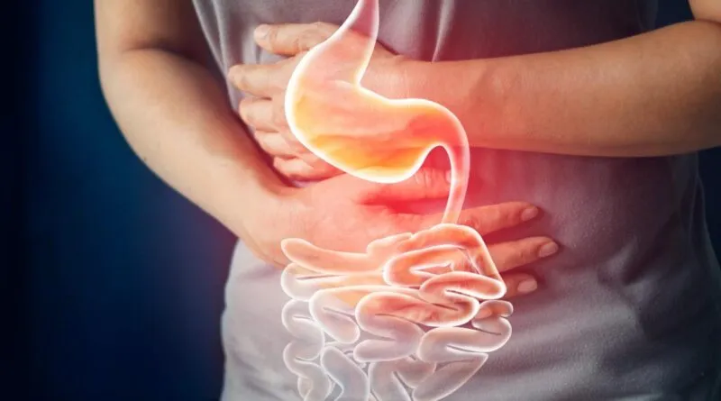 এক ব্যক্তি পেটে হাত দিয়ে দাঁড়িয়ে আছেন এবং তার পাকস্থলী ও অন্ত্রের একটি জ্বলজ্বলে চিত্র দেখা যাচ্ছে।