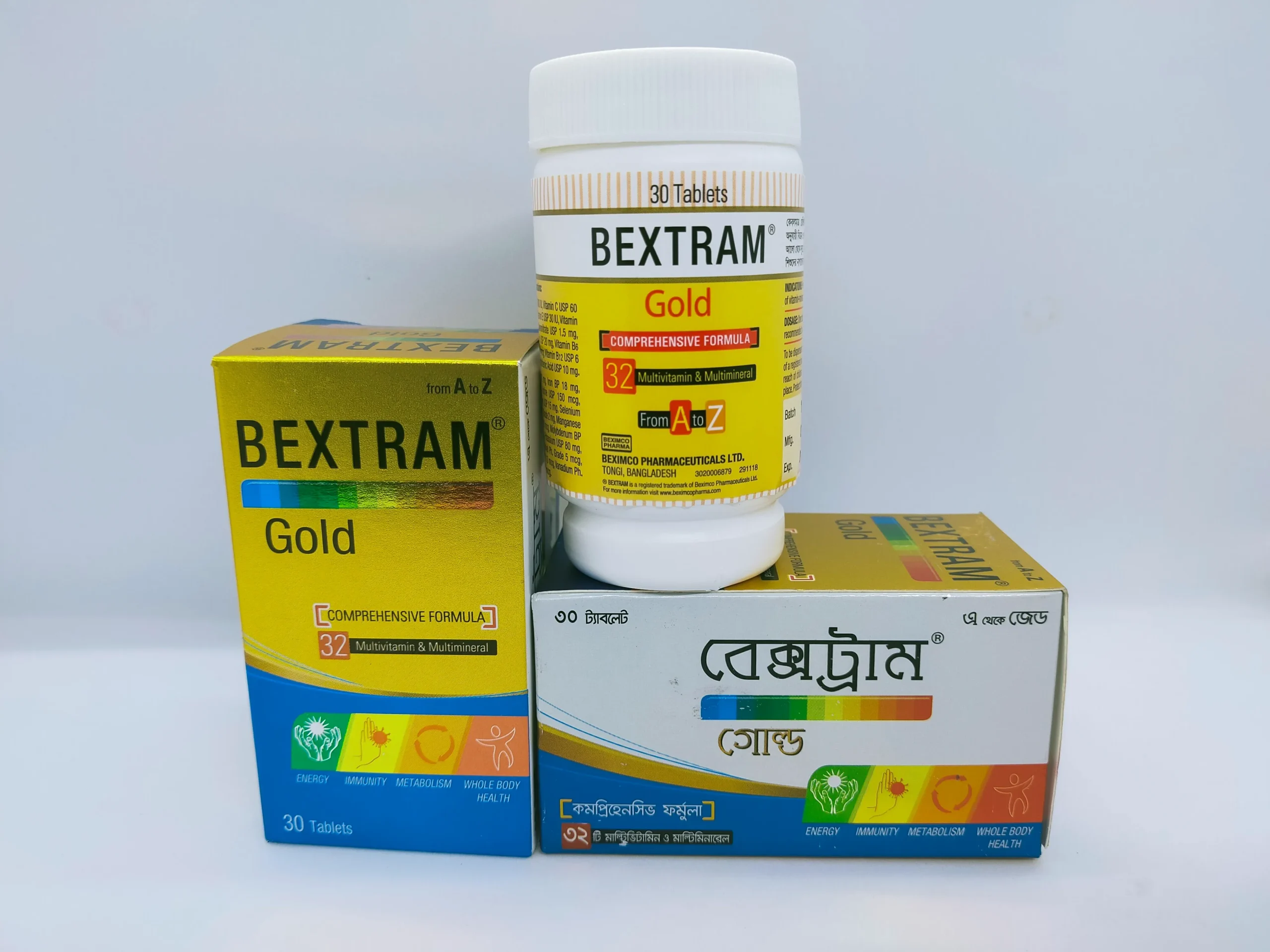 A white plastic bottle and two cardboard boxes of Bextram Gold multivitamin and multimineral tablets, showing packaging in both English and Bengali.