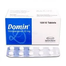 A box of Domin brand Domperidone 10 mg medication next to a blister pack containing ten white tablets.