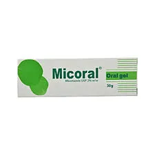A rectangular white box of Micoral Oral Gel featuring green circular graphics and text. The packaging indicates it contains 30g of Miconazole USP 2% w/w, intended for treating oral fungal infections.