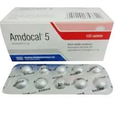 A white box and a silver blister pack of Amdocal 5 mg tablets by Beximco Pharmaceuticals. The packaging features red and blue accents with clear text indicating the dosage and quantity.