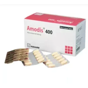 A white and pink box of Amodis 400 mg tablets with two aluminum blister packs of pills displayed in front.