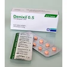 A white box of Denixil 0.5 mg labeled Clonazepam USP, placed next to a blister pack showing several small, peach-colored round tablets.