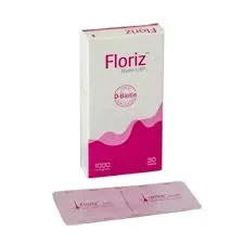 A box of Floriz Biotin USP 1000 microgram tablets standing behind a single pink and purple blister pack on a white surface.