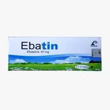 একটি সাদা ওষুধের বক্স যাতে বড় নীল অক্ষরে 'Ebatin' এবং তার নিচে (Ebastine 10 mg) লেখা আছে। বক্সটির নিচের অংশে সবুজ মাঠ ও নীল আকাশের একটি প্রাকৃতিক দৃশ্য দেখা যাচ্ছে।