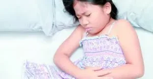 বিছানায় শুয়ে পেটে ব্যথায় কাতরাচ্ছে একটি ছোট শিশু।