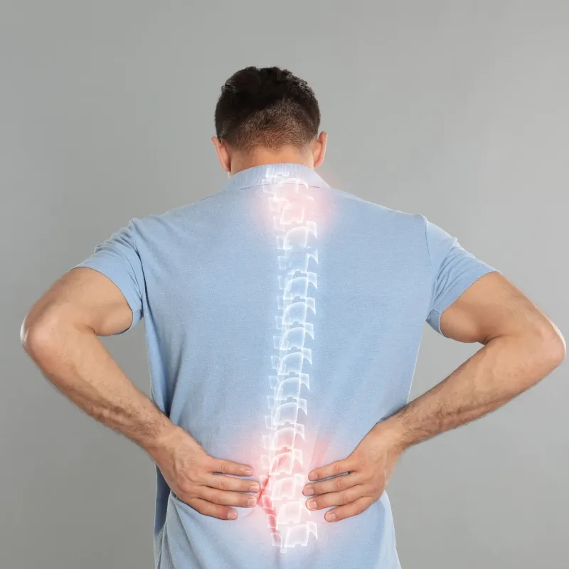 Back view of a man in a blue polo shirt with a semi-transparent graphic of a human spine overlaid on his back. Red glowing highlights on the upper and lower sections of the spine indicate areas of pain, inflammation, or injury.