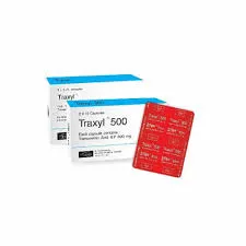 Two white boxes of Traxyl 500 capsules arranged behind a red-backed blister strip of medicine.