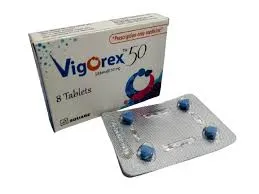 A white box of Vigorex 50 (Sildenafil 50 mg) medication sitting next to a silver blister pack containing four blue, diamond-shaped pills.
