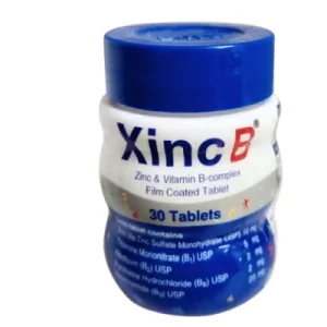 A small white plastic bottle of Xinc B supplement with a blue cap, featuring a label for Zinc and Vitamin B-complex film-coated tablets.