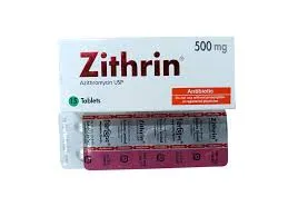 A white rectangular box of Zithrin 500mg tablets alongside a pink and silver foil blister pack, labeled as Azithromycin USP antibiotic.