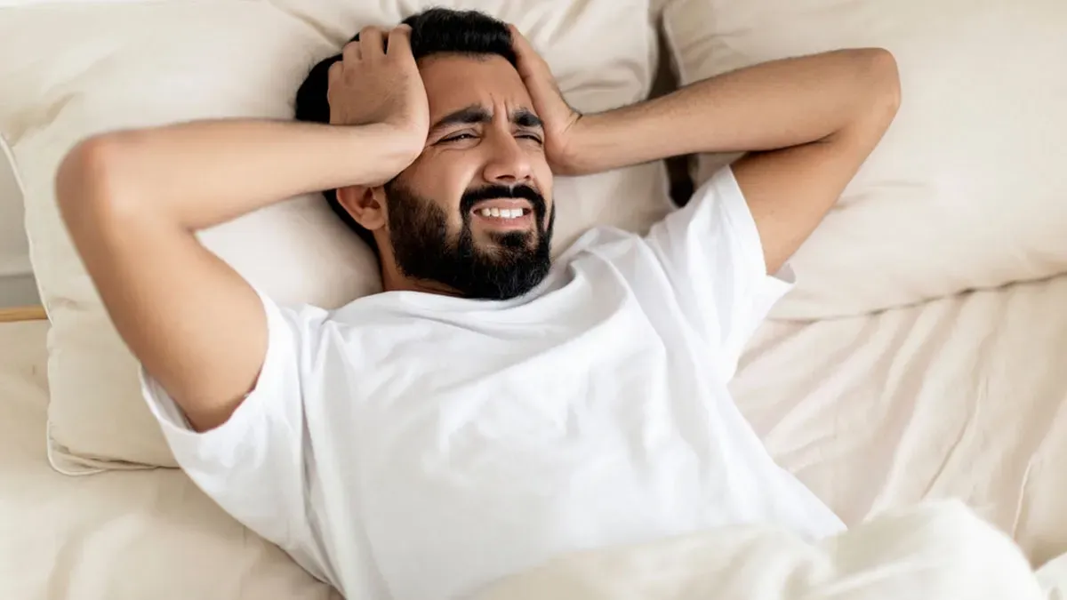 Man holding his head in pain due to migraine