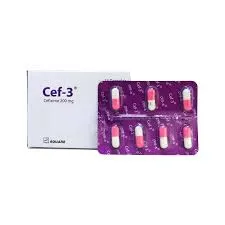 Front view of Cef-3 Cefixime 200mg medication box next to a purple blister pack of pink and white capsules.