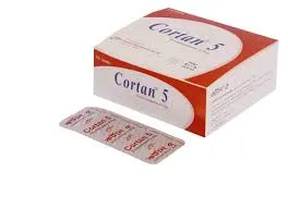 A white and red cardboard box of Cortan 5 (Prednisolone 5 mg) medication positioned next to a silver blister pack of tablets on a plain white background.