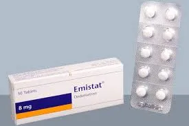 A white rectangular box labeled Emistat 8mg Ondansetron positioned next to a silver blister pack containing ten white circular tablets.