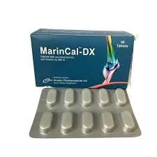 A straight-on shot of a blue MarinCal-DX box positioned behind a silver blister strip showing ten white medicine tablets.