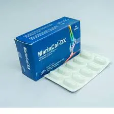 An angled view of a blue MarinCal-DX box sitting next to a white blister pack containing ten tablets on a light grey surface.