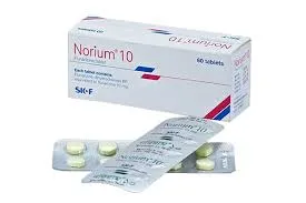 A white box of Norium 10 flunarizine tablets shown alongside two silver blister packs containing small pills on a plain background.