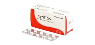 A white and orange box of Xyril 25 (Hydroxyzine Hydrochloride) medication sitting next to a silver blister pack containing small white tablets.