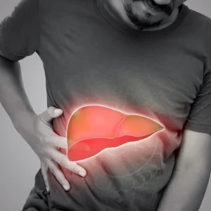A black and white image of a man clutching his side with a glowing, colorful graphic of a human liver overlaid on his abdomen.